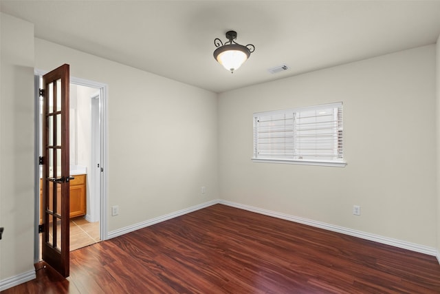 unfurnished room with hardwood / wood-style flooring