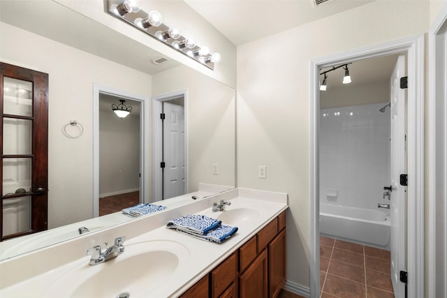 bathroom with tub / shower combination, tile patterned floors, and vanity