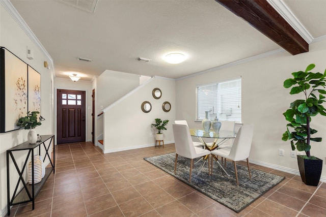 dining space with ornamental molding, tile patterned floors, and beam ceiling