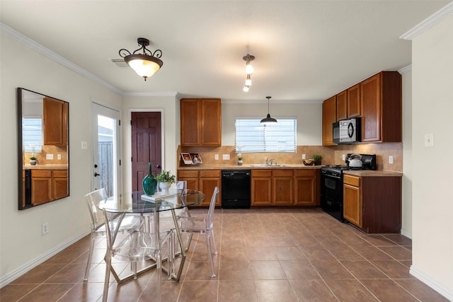 kitchen with black appliances, hanging light fixtures, tile patterned flooring, and crown molding