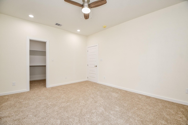 carpeted spare room with ceiling fan