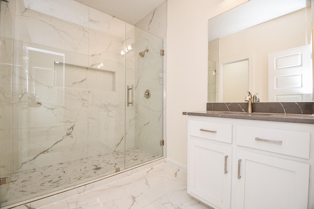 bathroom featuring a shower with door and vanity