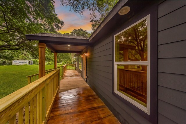 deck at dusk with a lawn