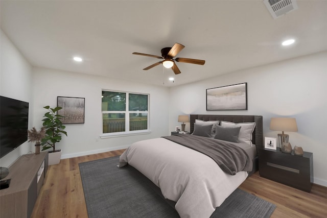 bedroom with hardwood / wood-style floors and ceiling fan