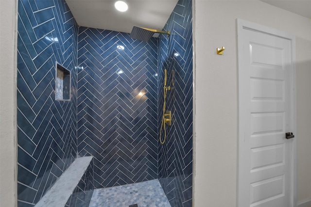 bathroom with a tile shower