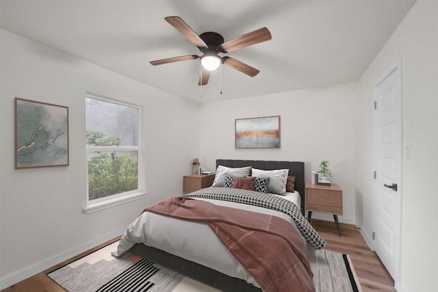 bedroom with ceiling fan and light hardwood / wood-style floors