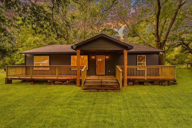 view of front of property featuring a yard and a wooden deck