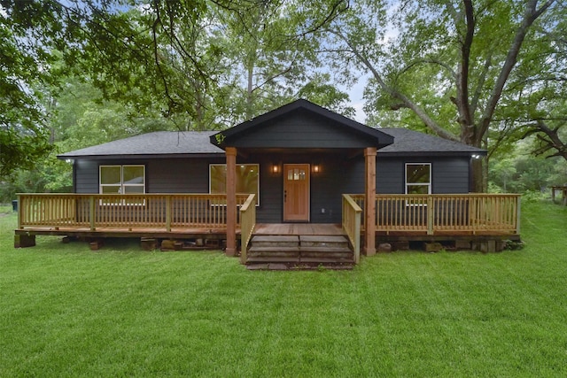 back of house featuring a yard and a wooden deck