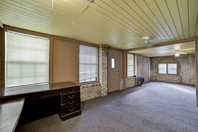 interior space with ceiling fan and wooden ceiling