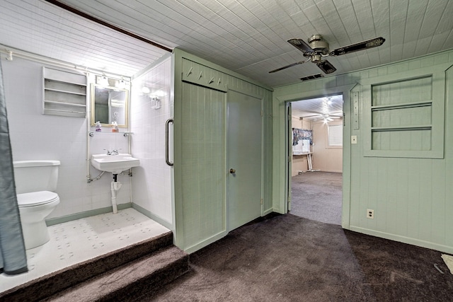 bathroom featuring toilet, ceiling fan, and walk in shower