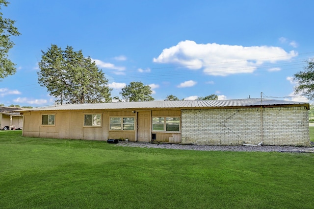 rear view of property with a lawn