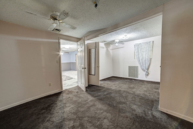 carpeted empty room with a textured ceiling