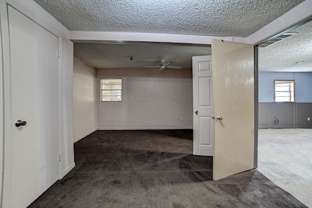 spare room featuring carpet floors, a textured ceiling, and beamed ceiling