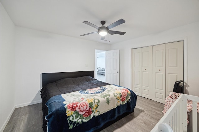 bedroom featuring wood-type flooring, a closet, and ceiling fan