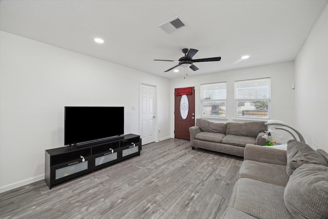 living room with light hardwood / wood-style floors and ceiling fan