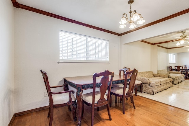 dining space featuring hardwood / wood-style floors, ceiling fan with notable chandelier, and plenty of natural light