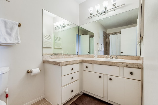 bathroom featuring curtained shower and vanity