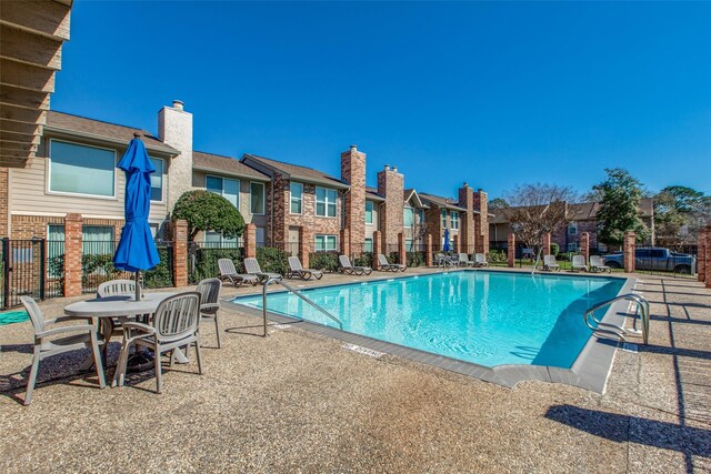 view of swimming pool with a patio area