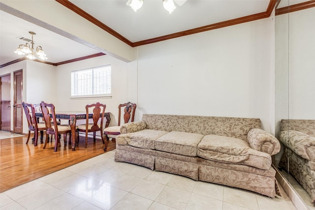 tiled living room with a chandelier and ornamental molding