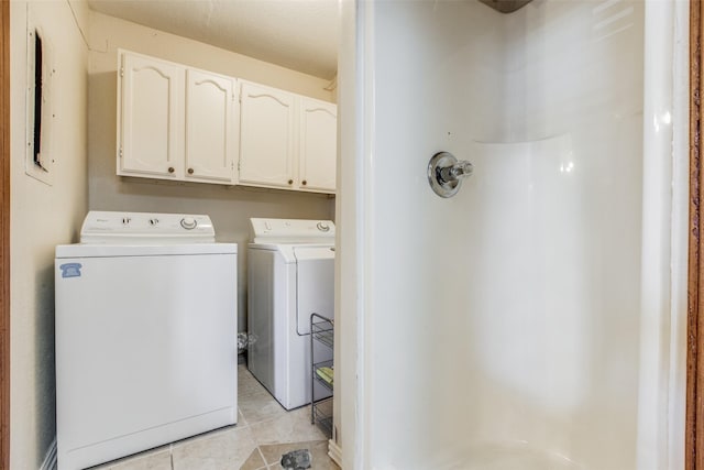 laundry room featuring light tile patterned floors and separate washer and dryer