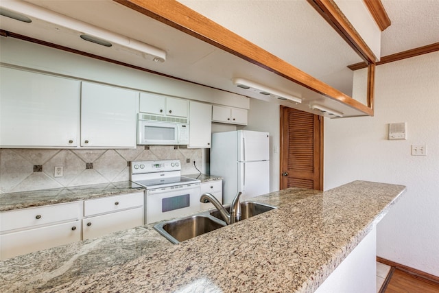 kitchen with sink, white cabinetry, white appliances, decorative backsplash, and light stone countertops