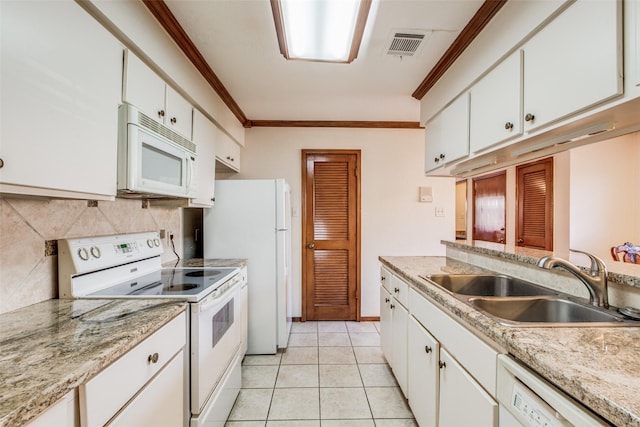 kitchen with white appliances, light tile patterned floors, white cabinets, ornamental molding, and sink