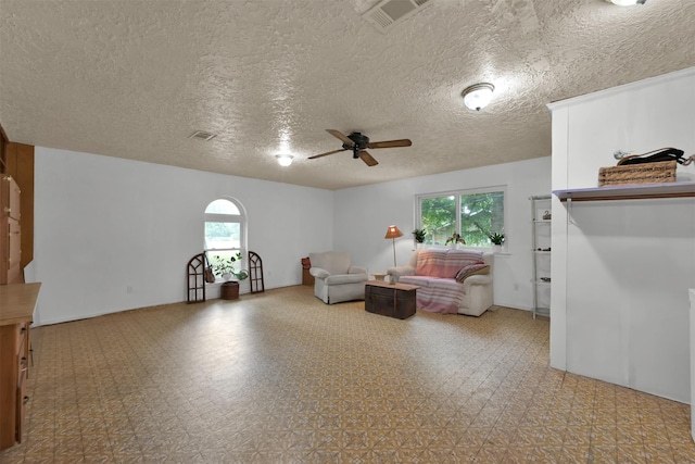 unfurnished room featuring a textured ceiling and ceiling fan