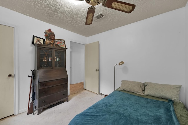 bedroom with ceiling fan and a textured ceiling