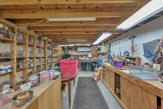 misc room featuring a workshop area and concrete flooring