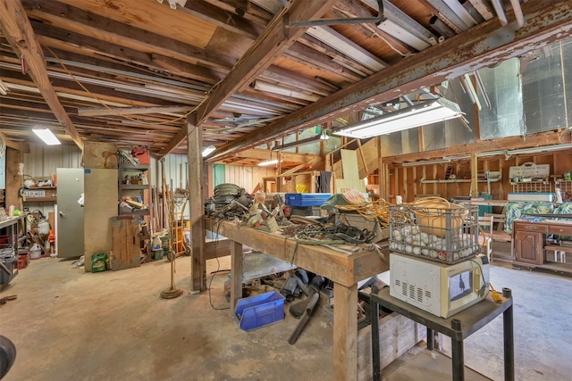 misc room featuring a workshop area and concrete flooring