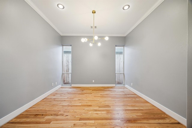 unfurnished dining area with a chandelier, ornamental molding, and light wood-type flooring