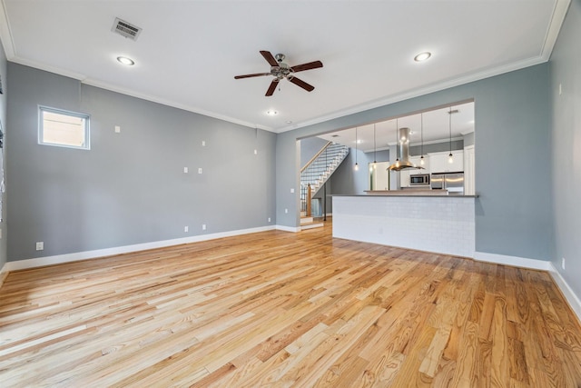 unfurnished living room featuring ceiling fan, ornamental molding, and light hardwood / wood-style floors