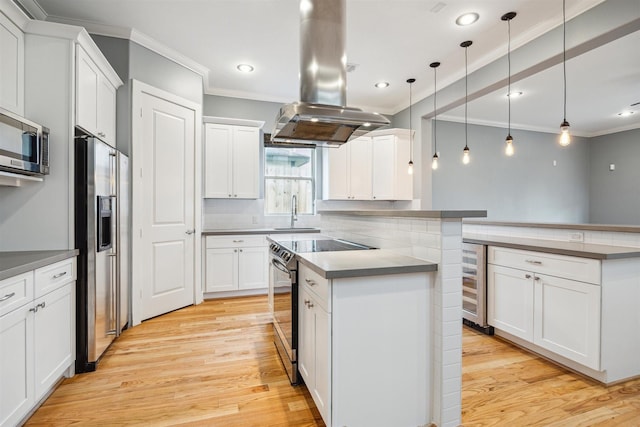 kitchen featuring decorative light fixtures, stainless steel appliances, island exhaust hood, backsplash, and white cabinets