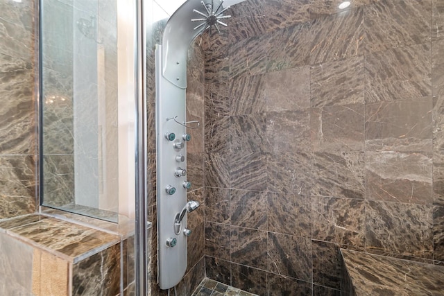 bathroom with a tile shower