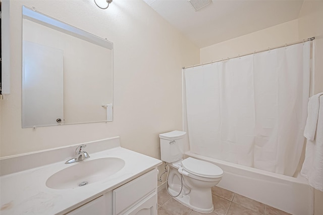 full bathroom featuring toilet, vanity, tile patterned flooring, and shower / tub combo with curtain