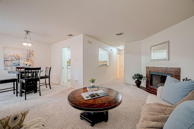 living room with a fireplace and light carpet