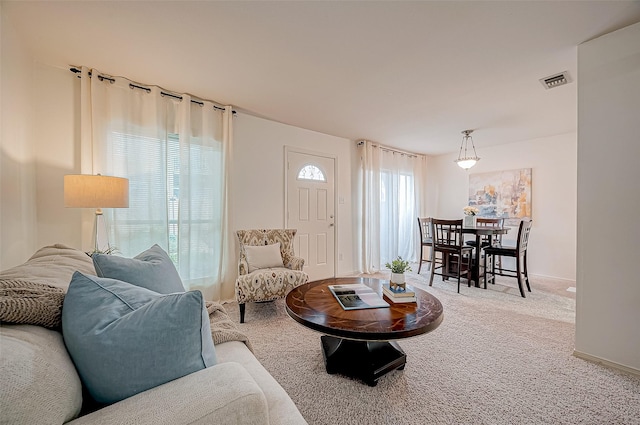 carpeted living room featuring plenty of natural light