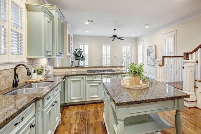 kitchen featuring sink, hardwood / wood-style flooring, ceiling fan, and stone counters