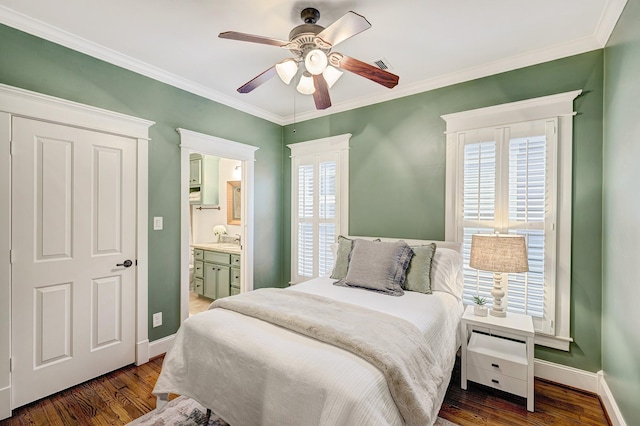 bedroom featuring ensuite bathroom, sink, ornamental molding, dark hardwood / wood-style floors, and ceiling fan