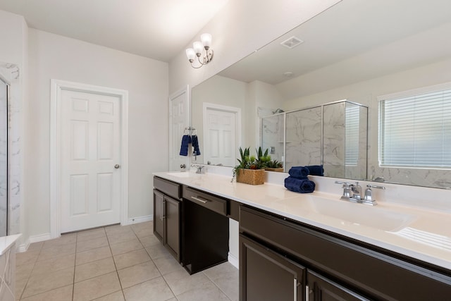 bathroom with vanity, tile patterned flooring, a shower with door, and a chandelier