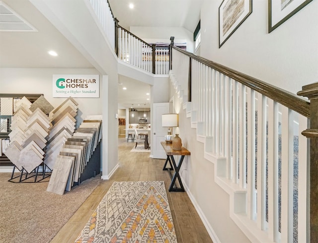 entryway featuring a high ceiling, recessed lighting, wood finished floors, and baseboards