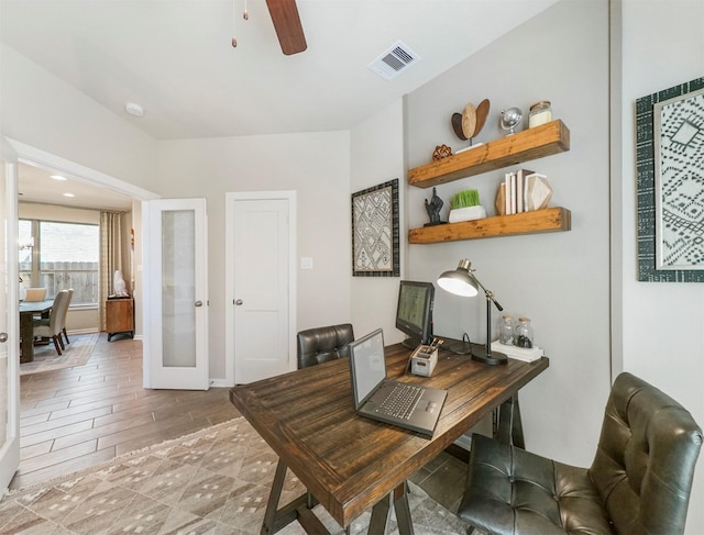 office with a ceiling fan, visible vents, baseboards, light wood-style flooring, and french doors