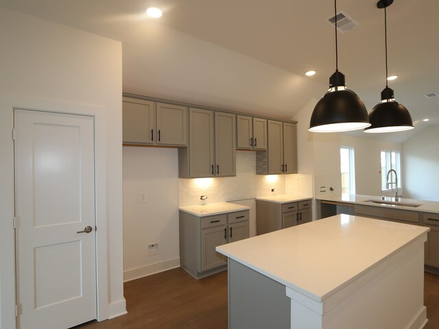 597 Copper Springs Dr, Magnolia, TX 77354 - kitchen featuring gray cabinets, a sink, dark wood-style floors, backsplash, and hanging light fixtures