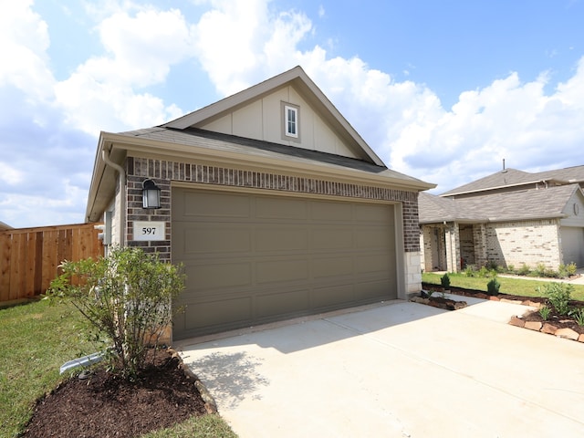 597 Copper Springs Dr, Magnolia, TX 77354 - view of front of house with driveway, board and batten siding, brick siding, and stone siding