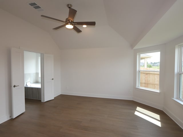 597 Copper Springs Dr, Magnolia, TX 77354 - empty room featuring vaulted ceiling, dark wood finished floors, ceiling fan, and baseboards