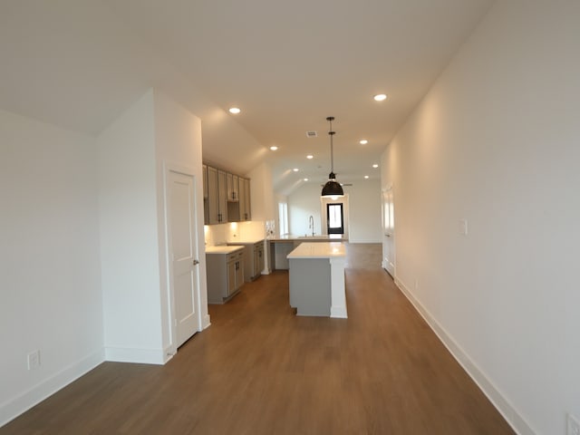 597 Copper Springs Dr, Magnolia, TX 77354 - kitchen with dark wood finished floors, light countertops, baseboards, gray cabinetry, and a center island