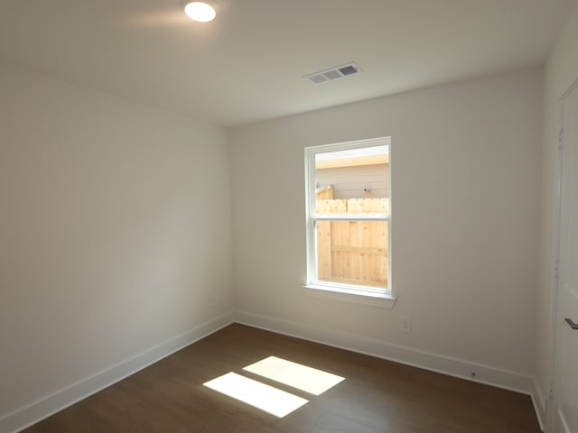 597 Copper Springs Dr, Magnolia, TX 77354 - spare room featuring dark wood-style floors and baseboards