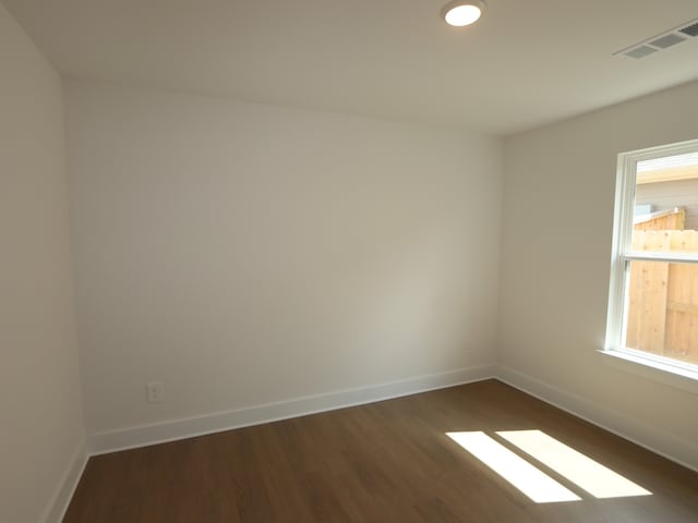 597 Copper Springs Dr, Magnolia, TX 77354 - unfurnished room featuring dark wood-style flooring, baseboards, and plenty of natural light