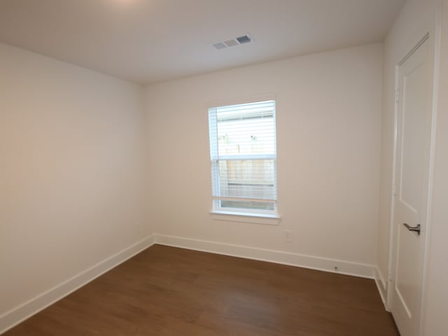 597 Copper Springs Dr, Magnolia, TX 77354 - empty room featuring baseboards and dark wood-type flooring