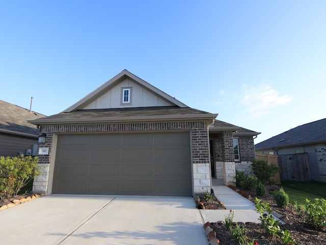 597 Copper Springs Dr, Magnolia, TX 77354 - ranch-style house with driveway, board and batten siding, stone siding, and a garage